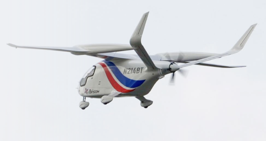 White small aircraft in flight with red and blue swoosh branding and Bristow logo, tail number N214BT, propeller spinning under a cloudy sky